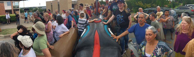 Here are people touching the totem pole as it makes its way to Florida.